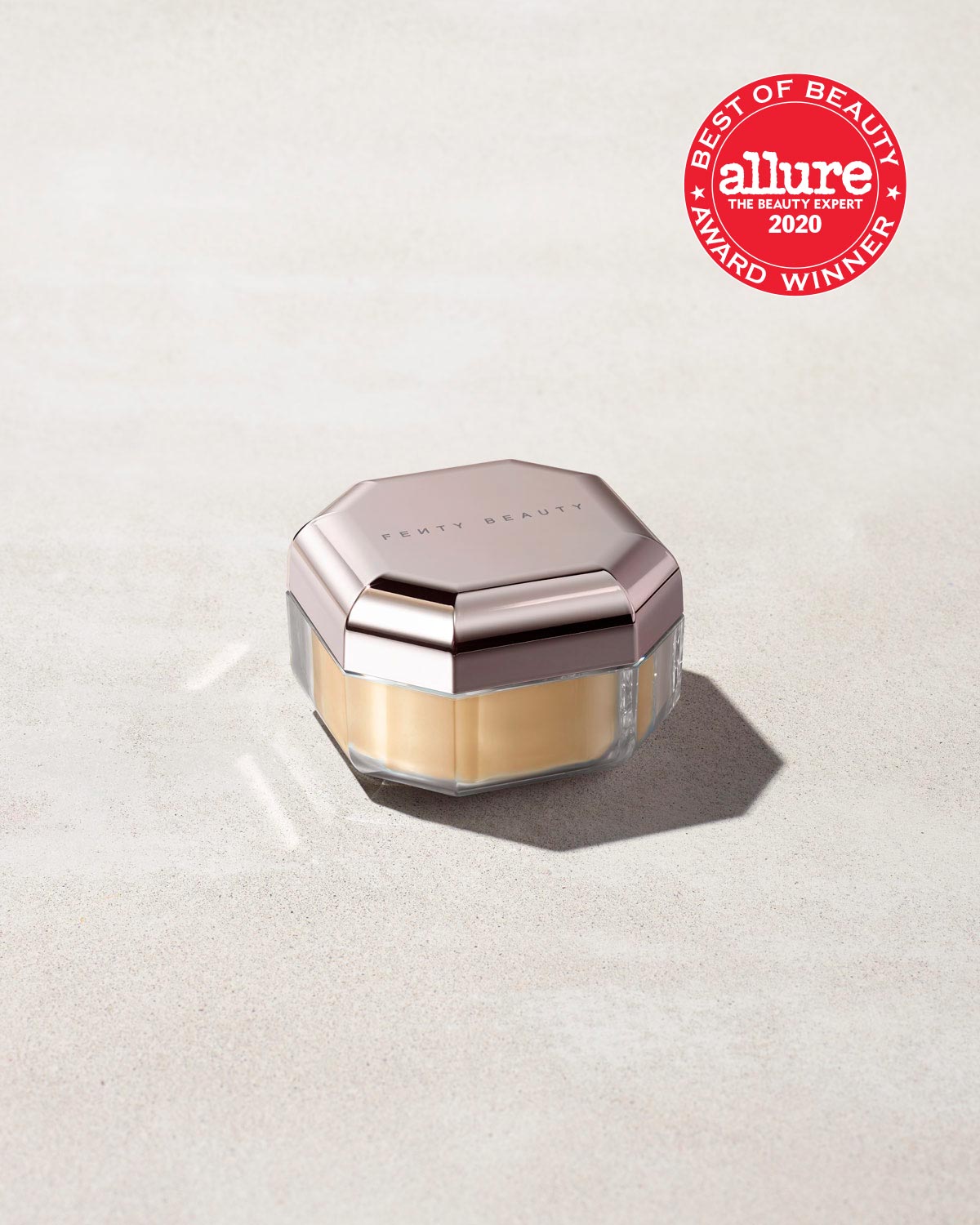  A jar of mini setting powder stood on a gray background with the Allure "Best of Beauty" award stamp overimposed