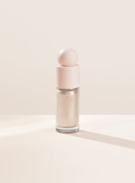 Enlighten| Rare Beauty's Positive Light Liquid Luminizer in the cool champagne shade "Enlighten."