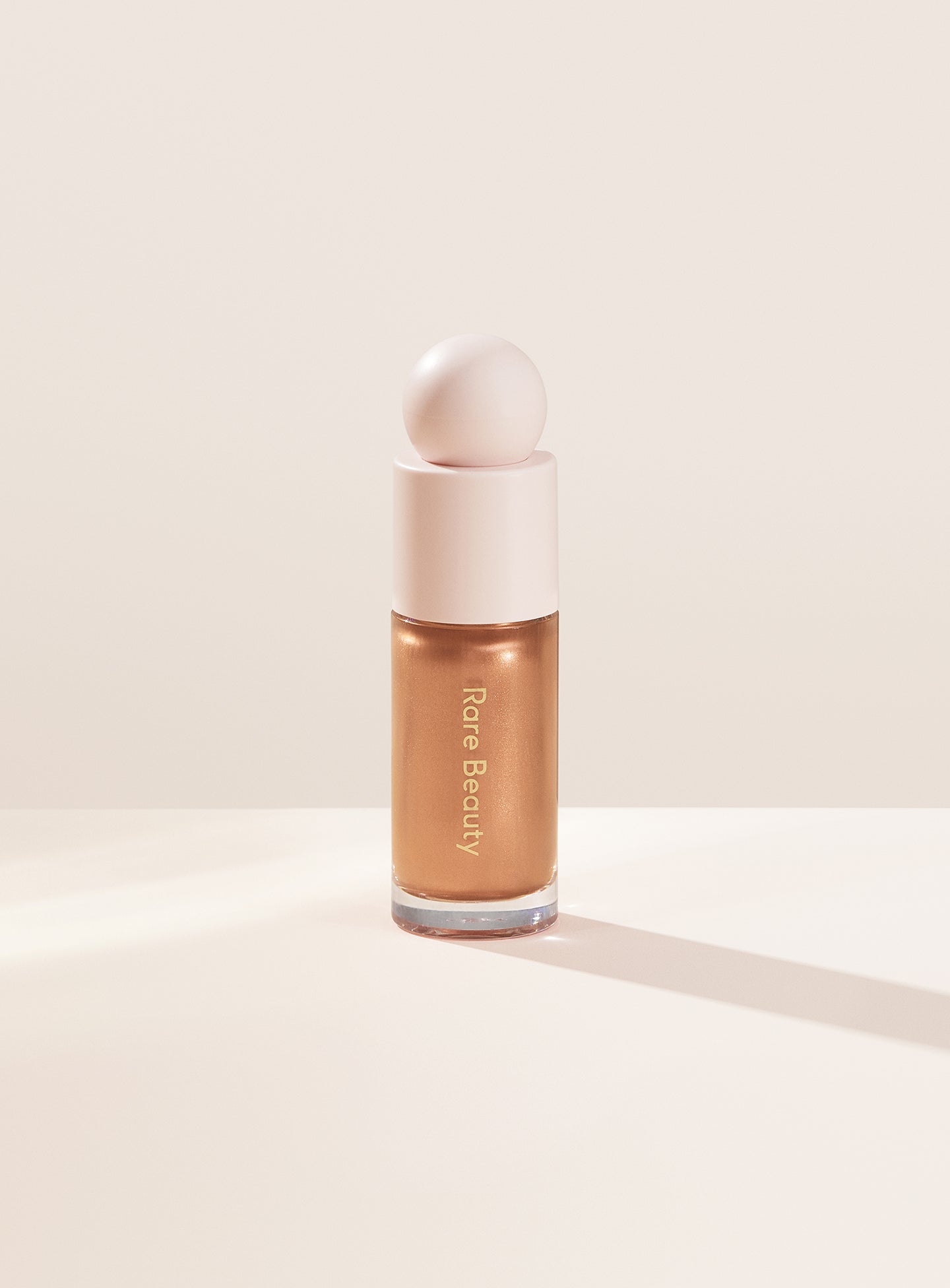 Flaunt| Rare Beauty's Positive Light Liquid Luminizer in the true gold shade "Flaunt."