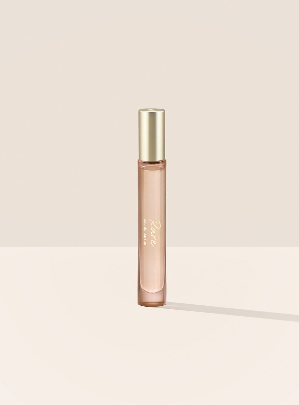 The Rare Eau de Parfum Travel Spray features a tubular bottle with a gold cap and script writing.