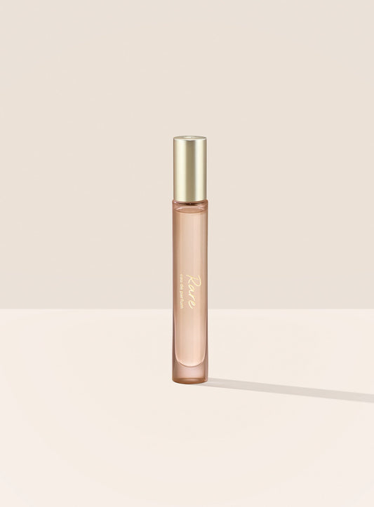 The Rare Eau de Parfum Travel Spray features a tubular bottle with a gold cap and script writing.