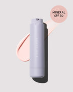 Bottle of Mineral Hydra Vizor Invisible Moisturizer Broad Spectrum SPF 30 Sunscreen with Niacinamide + Kalahari Melon on a lilac backdrop.